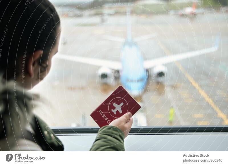 Anonymous person holding passport at airport window travel airplane anticipation journey flight departure young grip lookout view airfield transportation