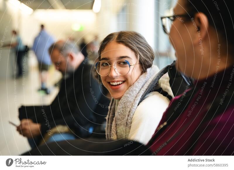 Smiling young woman enjoying family time in London women smile outing glasses cheerful indoor london scarf enjoyment happiness adult female lifestyle leisure