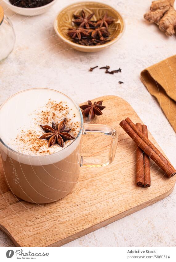 Delicious Chai Latte with Cinnamon and Star Anise chai latte chai tea spiced tea latte art star anise cinnamon sticks ginger root tea leaves frothy milk