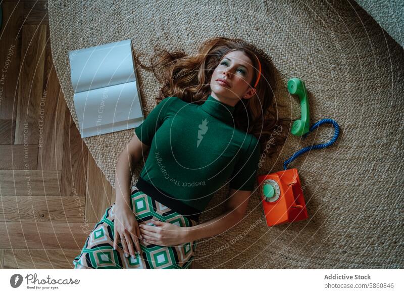 1950s housewife in a comical pose with an old telephone retro vintage rug woman lying down colorful dreamy looking away styled vibrant 50's scenario