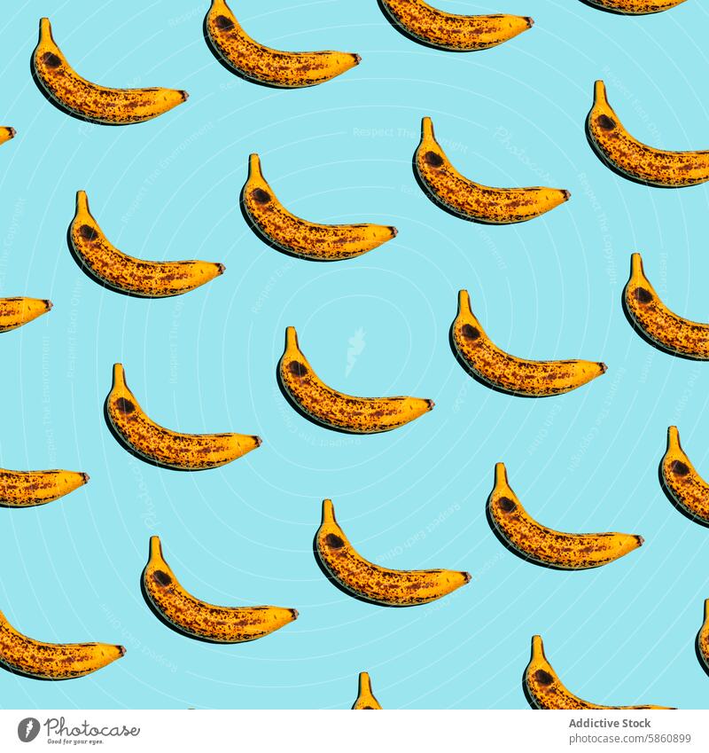 Repeating ripe banana pattern on a bright blue background fruit design quirky tropical repeat texture fresh natural spotted yellow brown food vibrant colorful