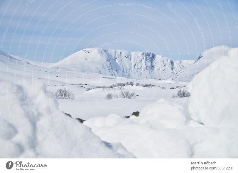 Norwegian high mountains in the snow. Mountains covered with snow. Scandinavia winter winter landscape ice cold tree frost white magic road light lantern motif