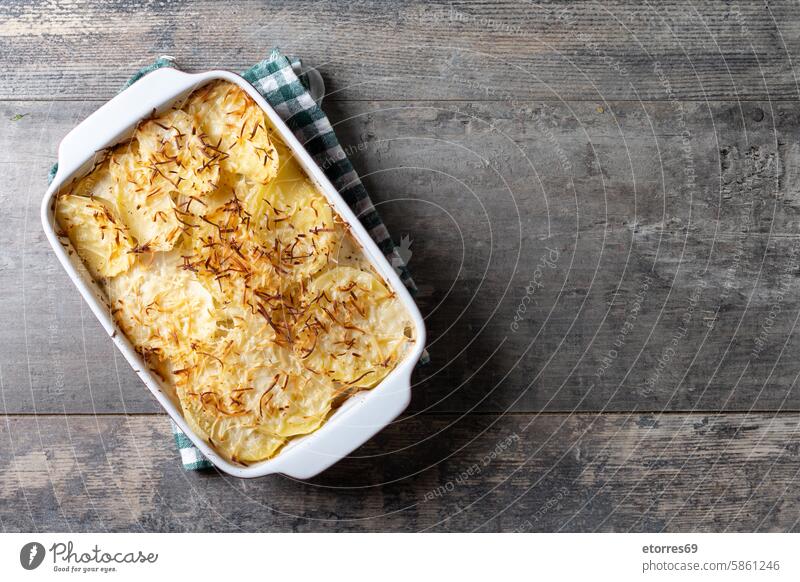 Potato gratin baked with cream and cheese on wooden table. Close up background cookieng cuisine food healthy meal potato