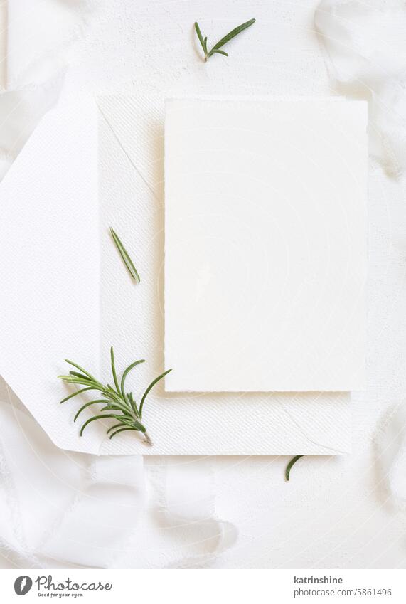Blank card and envelope near white silk ribbons and rosemary leaves top view, wedding mockup WEDDING romantic green paper valentine spring mothers day above