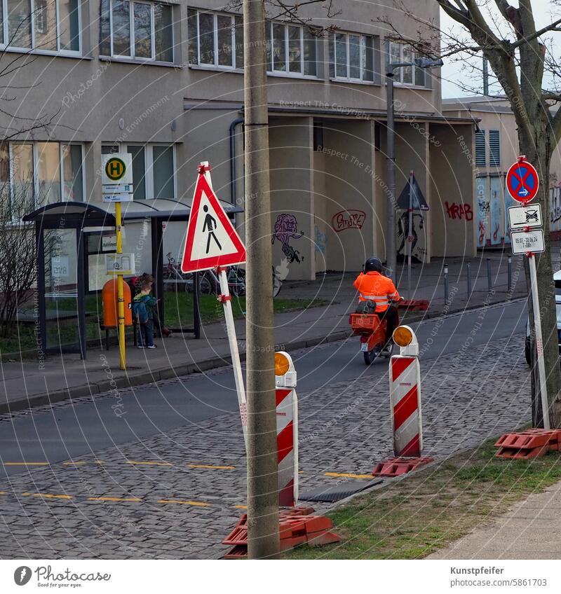 Closing time! Wearing a work jacket on a motorcycle through the maze of signs. construction works Road traffic urban Street Cobblestones Construction worker