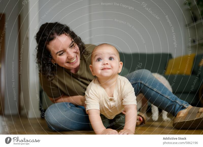 Caucasian mother playing with her baby on home floor caucasian joy infant wooden indoor family bonding love playful happiness child toddler woman smiling casual