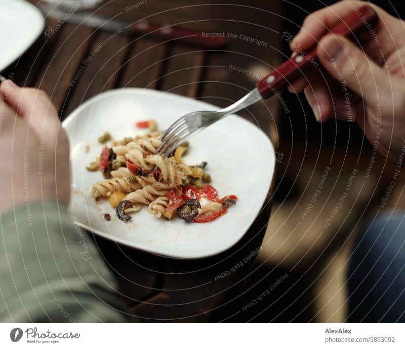 [HH Schregatour24] White plate with Italian-style spirelli salad being eaten with a fork by a man Plate white plate Crockery Cutlery Fork Table hands Male Hands