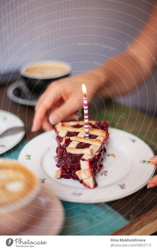 birthday cake cherry pie with a candle, make a wish. celebrating at party. cozy cottage core cafe. flame celebrate Birthday Candle Flame Colour photo