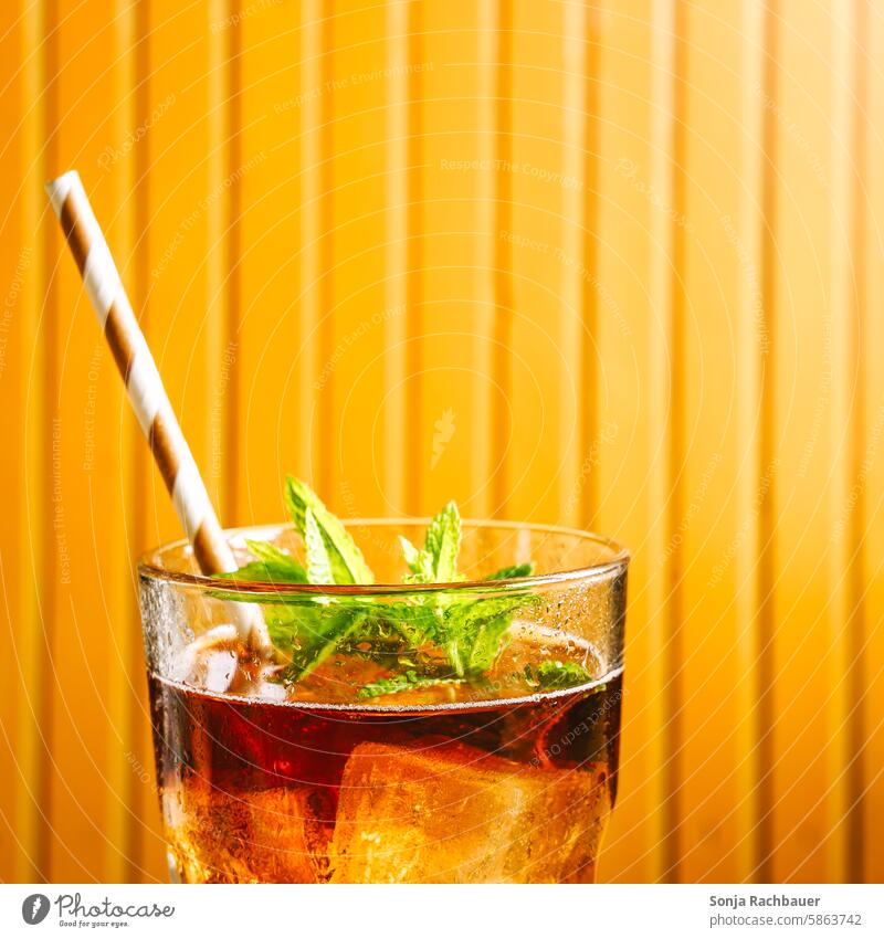 A glass of iced tea with ice cubes. Close-up. Iced tea Glass Ice cube Summer Beverage Cold Refreshment Lemonade Cold drink Fresh Delicious cute Drinking