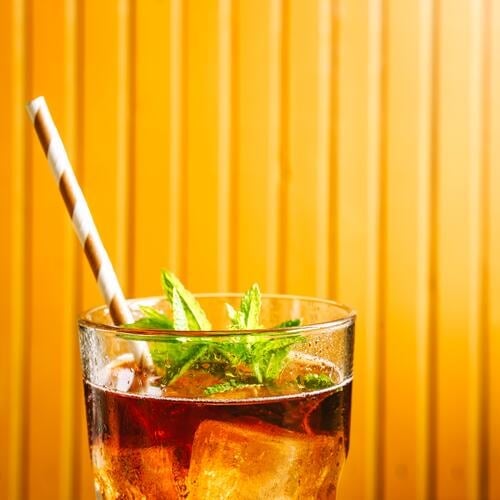 A glass of iced tea with ice cubes. Close-up. Iced tea Glass Ice cube Summer Beverage Cold Refreshment Lemonade Cold drink Fresh Delicious cute Drinking