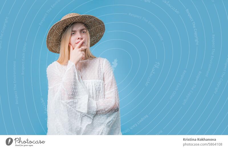 Thinking around stylish woman on blue background. Puzzled lady looking answer adult casual caucasian cheerful confident eureka expression face finger genius