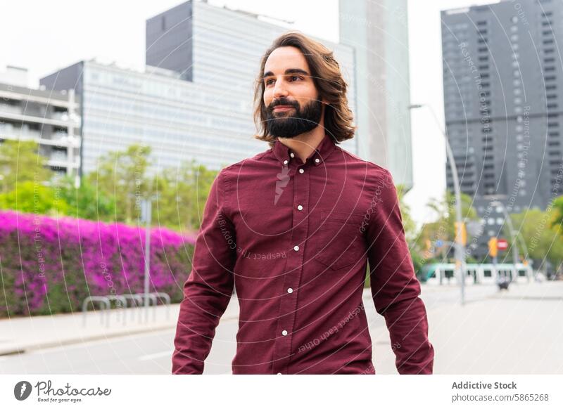 Casual urban lifestyle in Poblenou with stylish young man beard casual walking street poblenou barcelona city modern architecture vibrant smart shirt burgundy