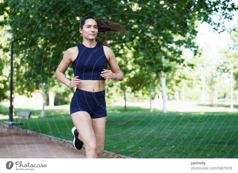 Young woman jogging outdoors, promoting fitness and healthy lifestyle in sportswear, reflecting vitality and wellness active activity athlete athletic cardio