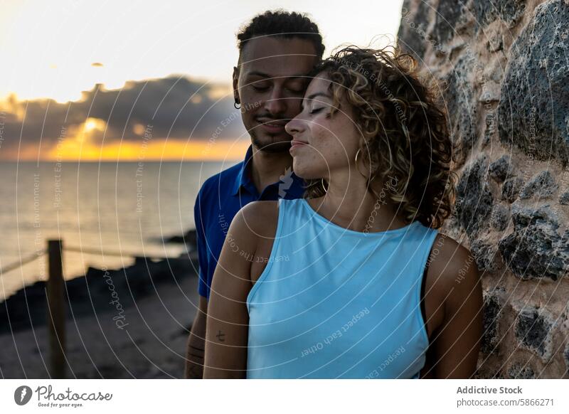 Couple embracing at sunset by the sea couple embrace romantic love gentle caucasian woman affection togetherness bonding relationship evening outdoor nature