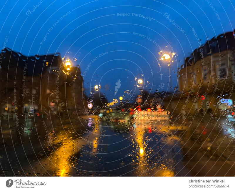 Empty crossroads in rainy weather Rainy weather clearer Lights in the rain Wet Illuminate hazy blue hour Mood lighting Shifty weather houses Hazy raindrops