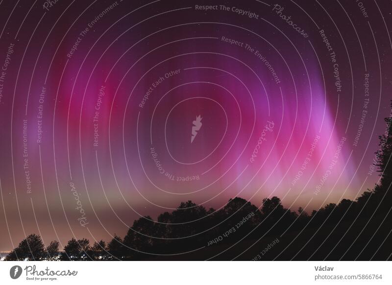 Pink, yellow and red aurora dancing over the Czech Republic. A great solar storm. Night sky under a geomagnetic storm turning pink. A miracle in the Czech Republic. Northern lights