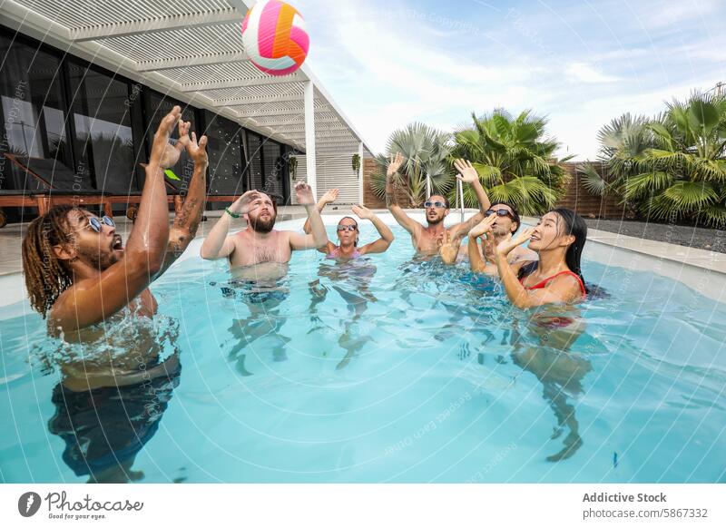 Friends playing ball in a pool during a summertime gathering friends fun water splashing cheerful group outdoor multiethnic party diversity modern architecture