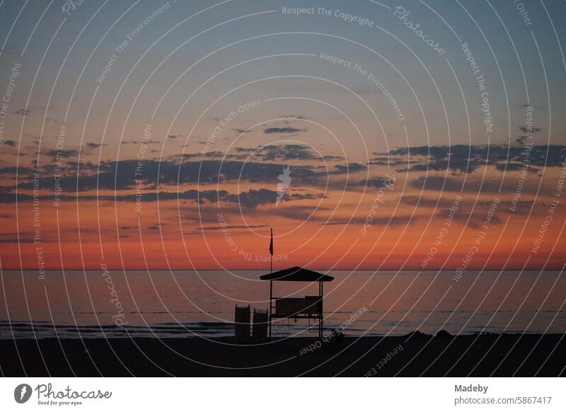 Silhouette of a high seat after sunset on the beach of Inkumu on the Black Sea near Bartin on the Black Sea coast in Turkey Flag Twilight relaxation Meditation