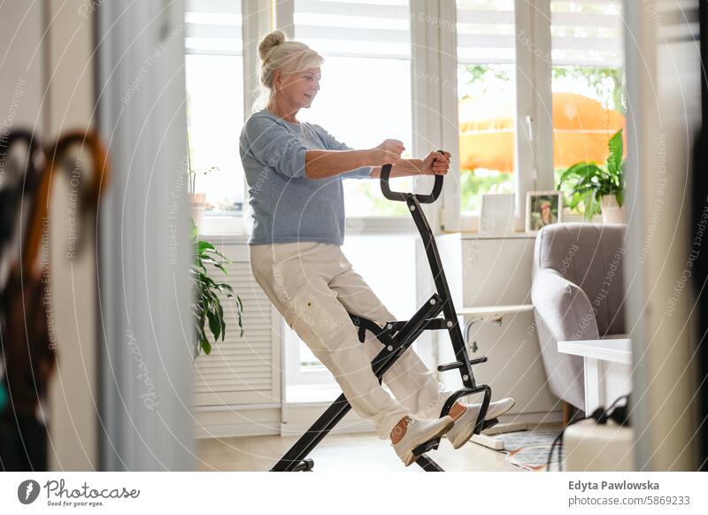 Active senior woman training at home people mature female elderly house old aging domestic life grandmother pensioner retired retirement wrinkles gray hair