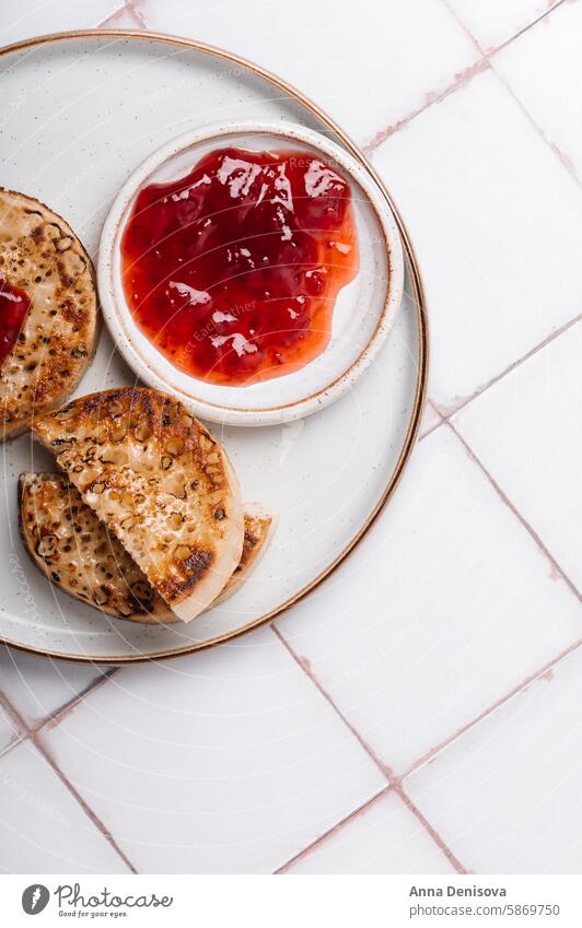 British popular breakfast - toasted crumpets jam hot table scone tasty food snack english traditional spongy british butter delicious pikelets griddle bread