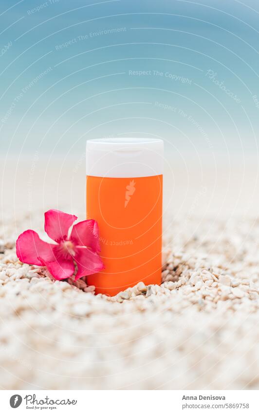 Sunscreen bottle on the beach sunscreen summer product pebbles sand skin sunblock landscape template mockup layout mock up sea ocean water healthy advertising