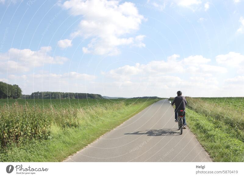 on the road by bike ... Human being Man Senior citizen Rear view Bicycle Cycling Cycling tour Landscape Street Field Grass Meadow acre Plant Summer