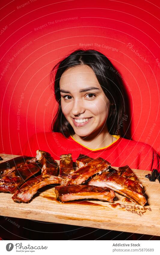 Woman presenting delicious barbecue ribs on table woman red vibrant dining food meal succulent serving posing smiling experience enjoyment savory tasty cuisine