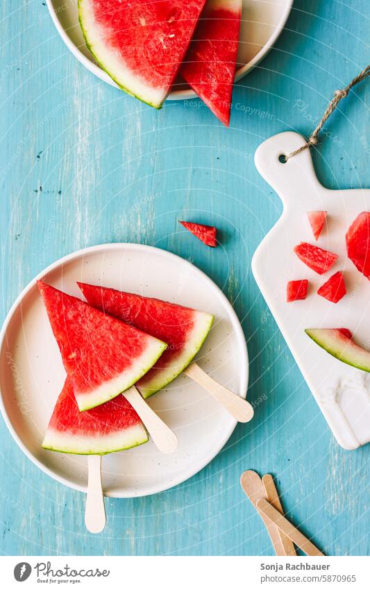 Pieces of fresh watermelon on a plate. Top view, turquoise table. Water melon slice Plate fruit Summer Fresh Delicious Red Healthy cute Mature naturally Tasty