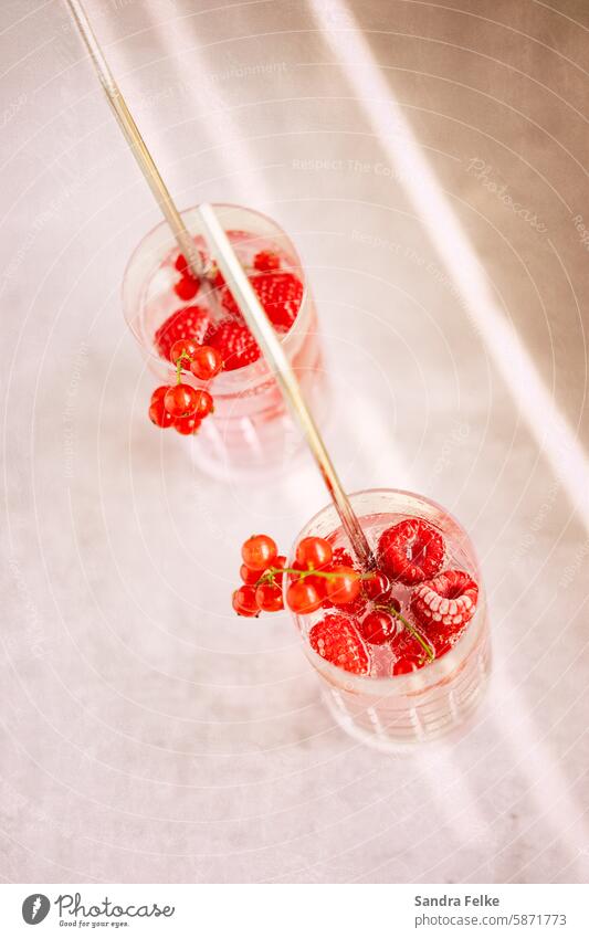 2 long drinks with frozen fruit and straw from the top Longdrink Berries Beverage Cocktail Glass Colour photo Cold drink Lemonade Delicious Ice cube Fresh