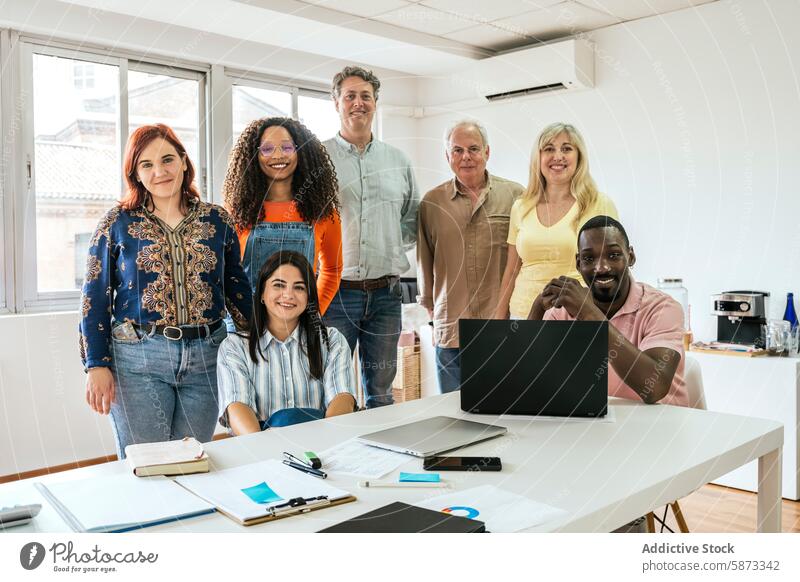 Diverse team smiling together in bright coworking space office teamwork collaboration professional diverse women multiracial multiethnic modern workspace group