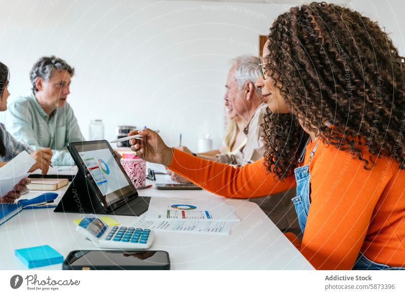 Diverse team collaborating in a modern coworking space collaboration professional diversity multiracial african american tablet discussion workspace women