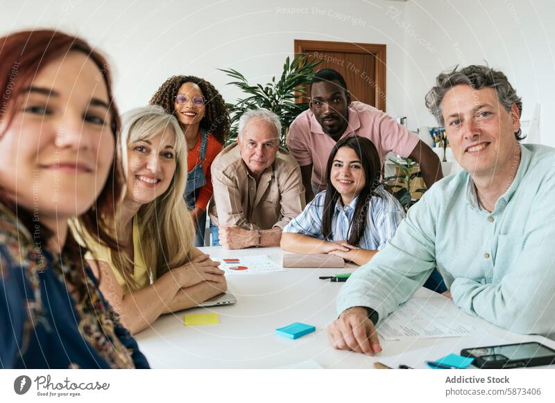 Diverse group of colleagues collaborating in a modern coworking space selfie collaboration meeting teamwork professional workplace office multiethnic diverse