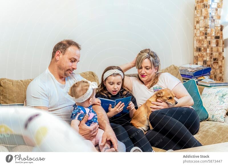 Family enjoying time together at home with a dog family couch child adult pet reading playing interaction bonding cozy indoor living room leisure weekend fun