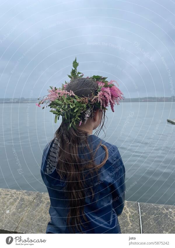 Child from behind with flowers in her hair on a rainy day rainy weather Autumn Autumnal autumn atmosphere Rain Weather Gray somber Dreary Rainy weather