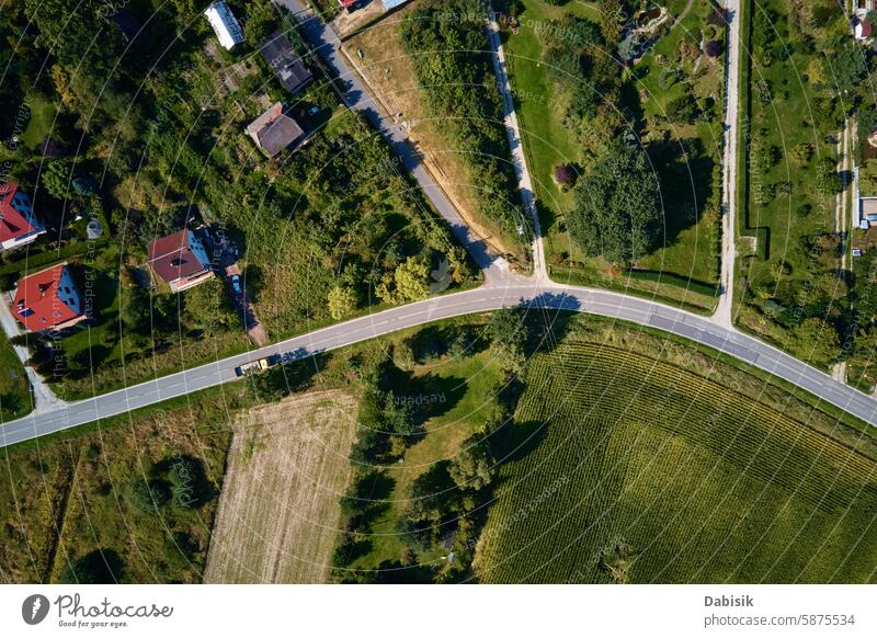 Aerial View of Countryside Road and Fields aerial view countryside road fields houses greenery landscape nature rural farmland scenic sunny day agriculture