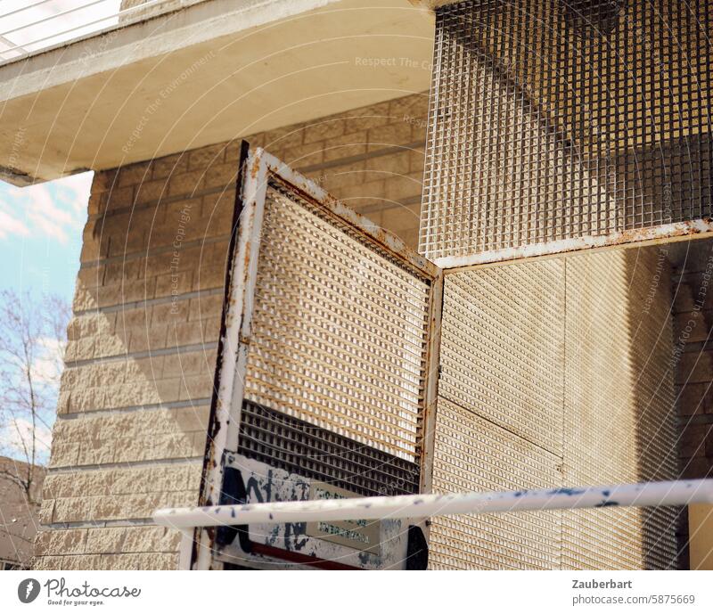 Barred gate stands open, geometric structure in sand color Goal Open Grating Sand color urban Dismissive Cold Sparse latticed Metal Structures and shapes Safety