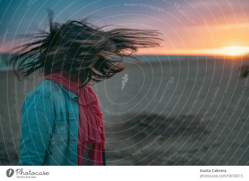 Woman's hair moves in the wind at sunset on the beach. Woman`s head Sand Sandy beach Sunset Sunlight Beach Vacation & Travel Hair Colour photo Summer vacation