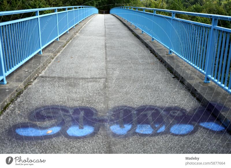 The Blue Bridge for pedestrians over the tunnel road with graffiti in Oerlinghausen near Bielefeld on the Hermannsweg in the Teutoburg Forest in East Westphalia-Lippe