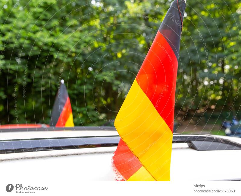 German flags on the roof of a soccer fan's car Patriotism Pride sporting event Ensign Germany black-red-gold Car roof EM Foot ball Fan fan culture