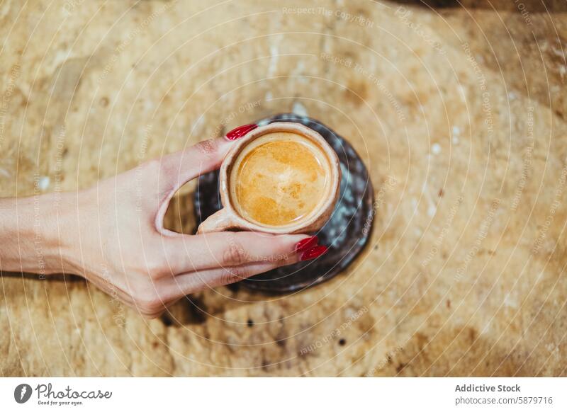 Close-up of female hand holding espresso cup woman coffee nail polish red close-up texture rustic table beverage morning ceramic small drink caffeine touch grip