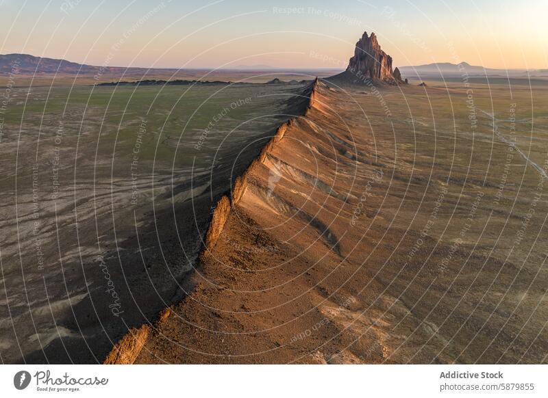 Warm sunset light on Shiprock in New Mexico desert shiprock new mexico plains warm iconic formation landmark nature landscape scenic vast outdoor