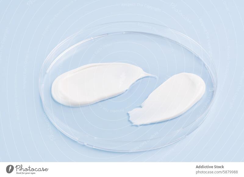 Cosmetic smears displayed on a soft blue background cosmetic beauty skincare cream product texture sample elegant fresh presentation transparent dish concept