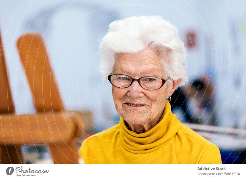Elderly woman in yellow top with a warm smile elderly senior mature glasses white hair gentle joyful active vibrant lifestyle happy cheerful aging positivity