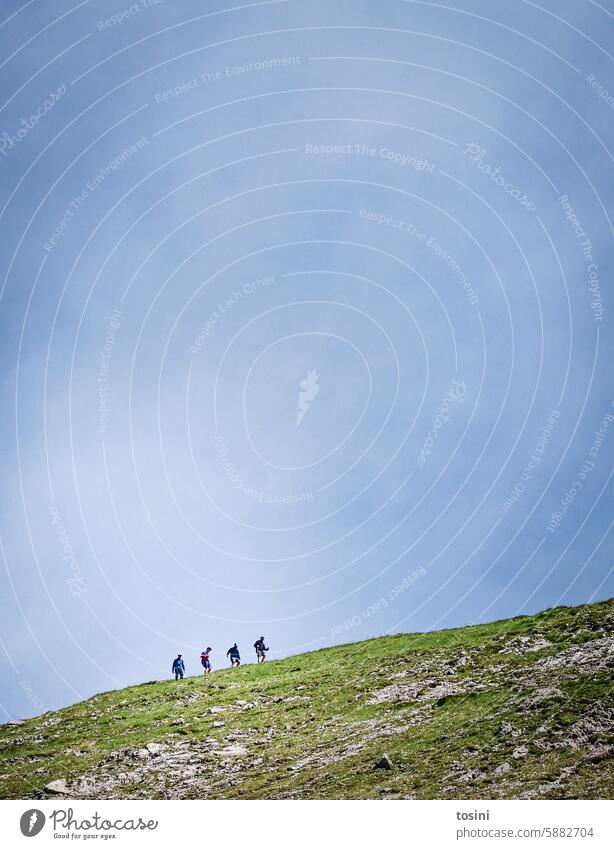 Four people standing in a row on a ridge (2/2) Mountain mountains Sky Peak Exterior shot Alps alpine crossing alpine landscape hike ascent Effort Row Landscape