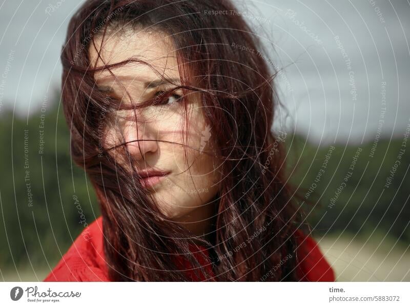 Woman in the wind portrait feminine Feminine Long-haired Looking Face Dark-haired Meditative Horizon Summer View to the side Blown away Skeptical