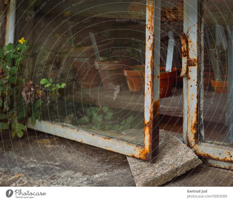 Rusty window with flower pots Old Nature Patina Metal Exterior shot Colour photo Deserted Transience Structures and shapes Decline Ravages of time Change rusty