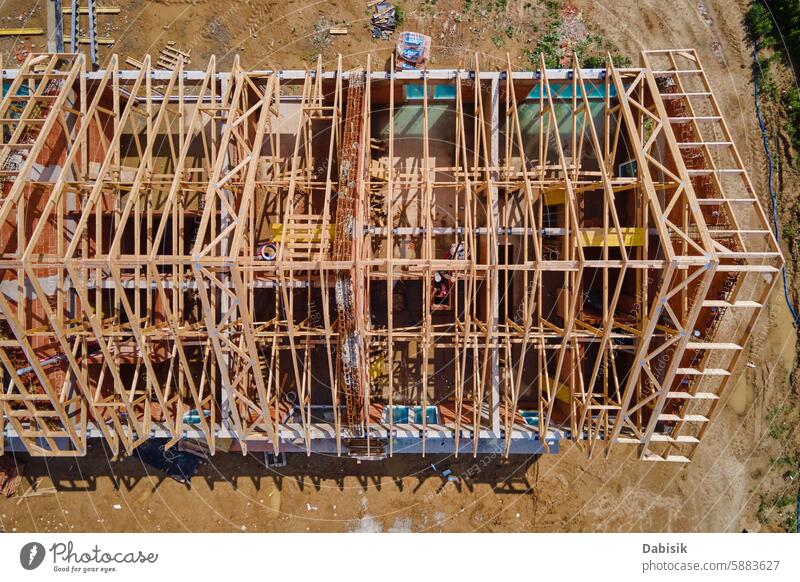 Aerial View of New Home Under Construction With Truss Roof construction house roof truss framing wooden beams building new project real estate residential home