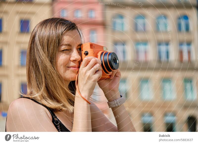 Young Woman Taking Photos in European City woman camera travel tourism photographer European city historic architecture city square colorful buildings memories