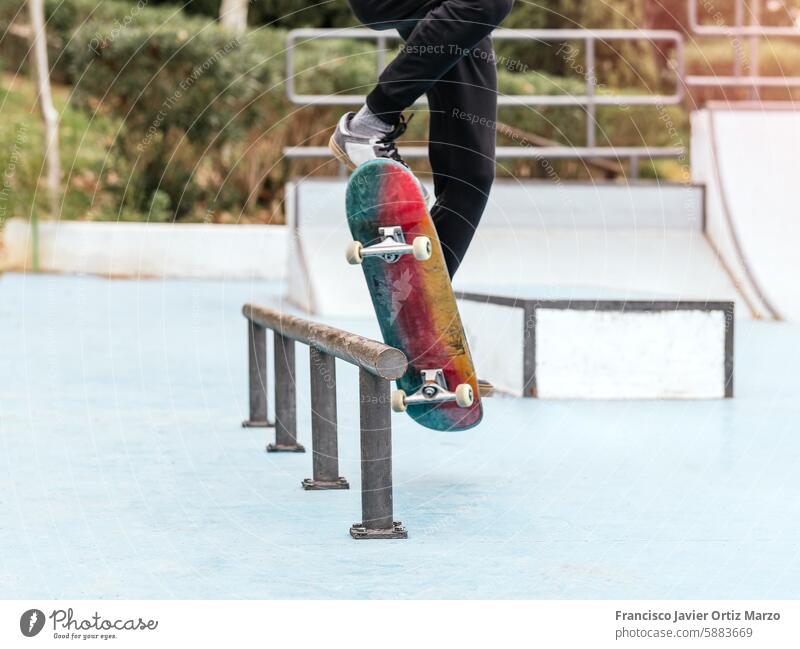 Skateboarder performing a trick on a rail at a skatepark. boy skateboarder skateboarding outdoor action sports recreation balance skill ramp jump grind athlete