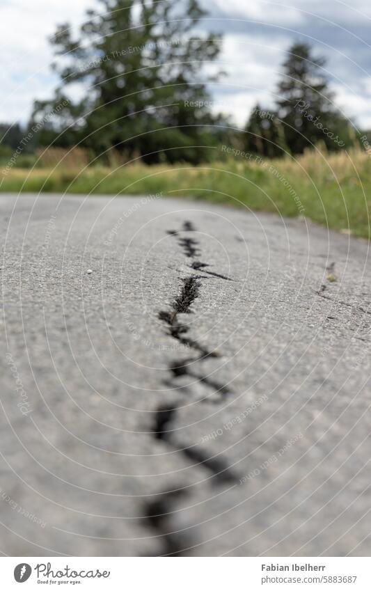 Cracks in asphalt Pothole road damages Crack & Rip & Tear Asphalt Country road Crack filler Germany